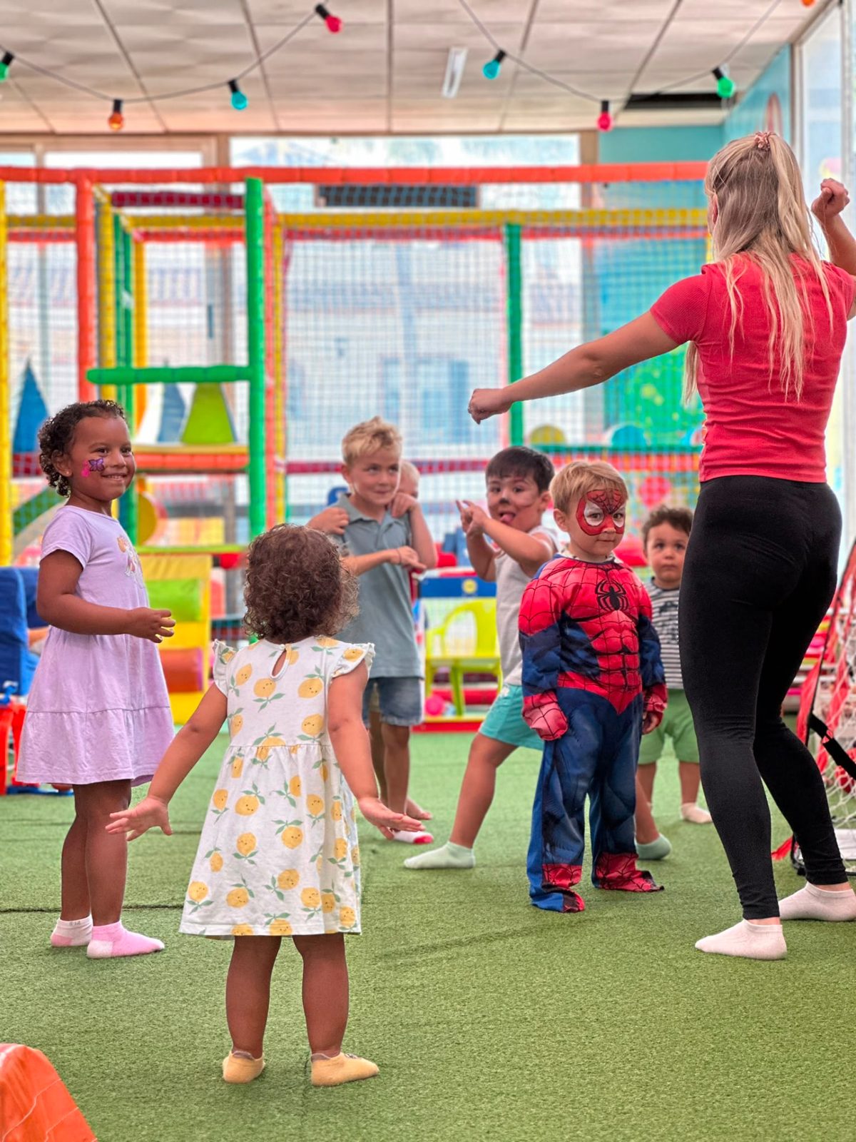 Children dancing together during an activity at Dream Park